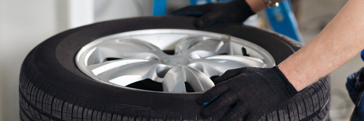 Mechanic holding a tyre - Tyres Northampton